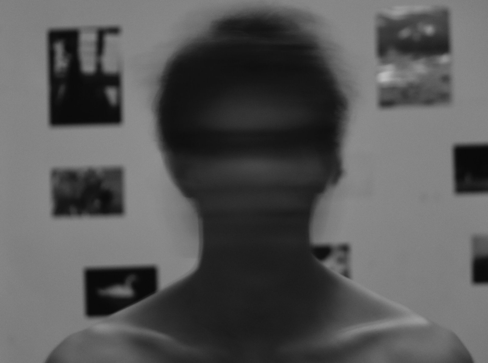 A blurred human figure in monochrome, symbolizing identity erasure and silent digital compromise.