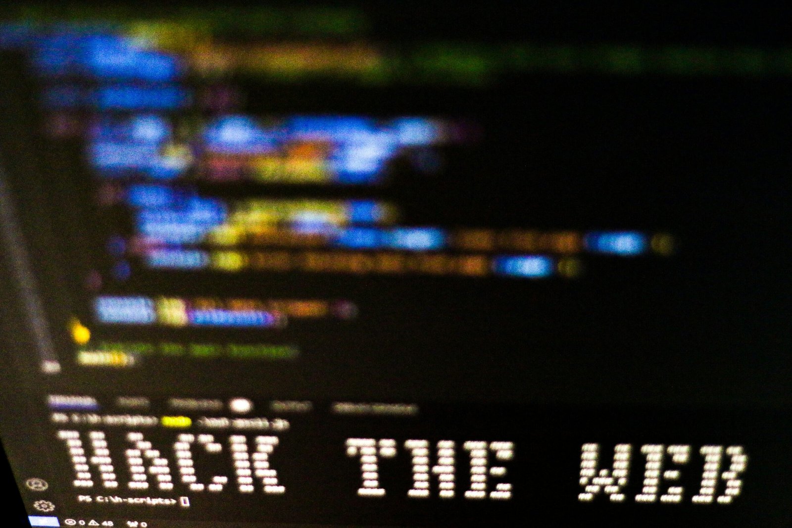 Blurred computer code and warning text representing overlooked cyber threats and digital risks.